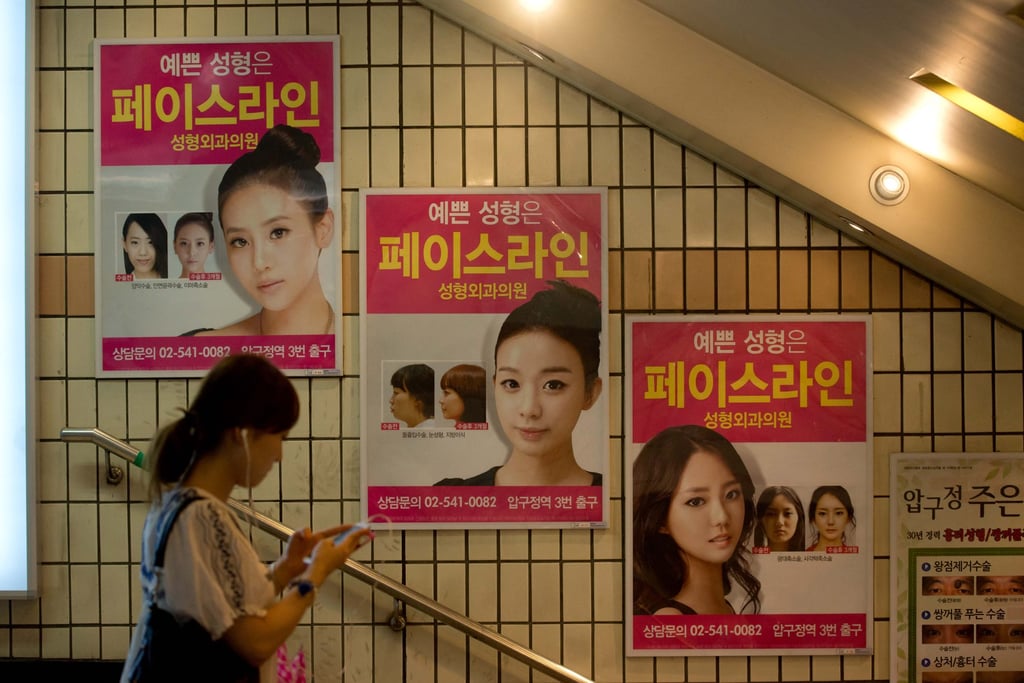 Advertisements for plastic surgery clinics are displayed at a subway station in Seoul. Photo: AFP