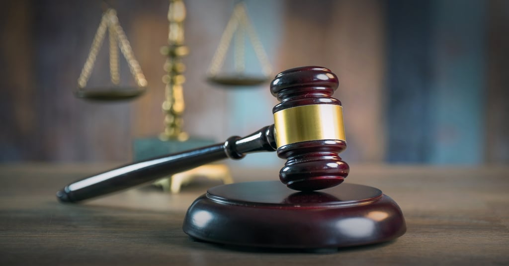 A judge’s gavel is pictured, with the scales of justice in the background. The suspects in the case were ordered to surrender their passports and stay away from the victims. Photo: Shutterstock