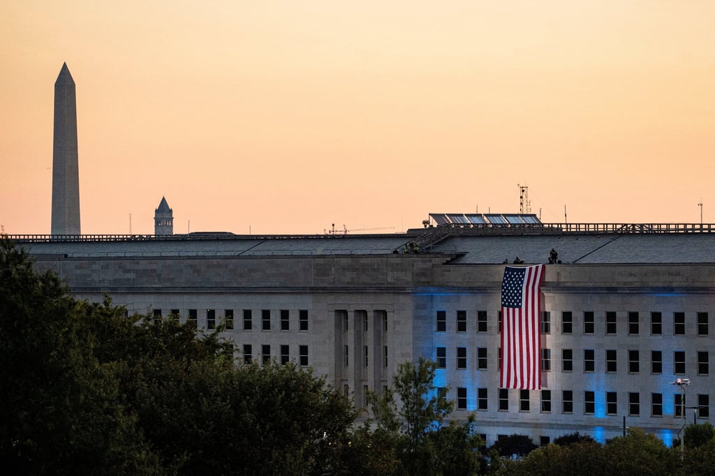 An American flag is unfurled from the roof of the Pentagon. A Pentagon spokeswoman last month said a security forum promoted “the evil of globalism, disdain for our great country and hatred” for the US president. Photo: Reuters
