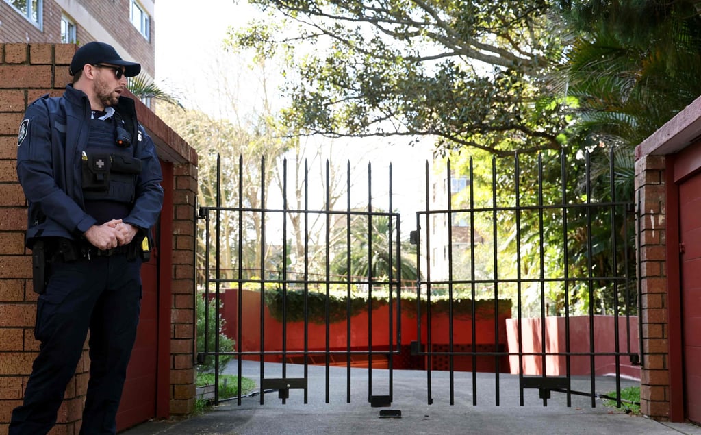 A police officer stands guard outside the gates of the Russian consulate in Sydney on Monday. Photo: AFP