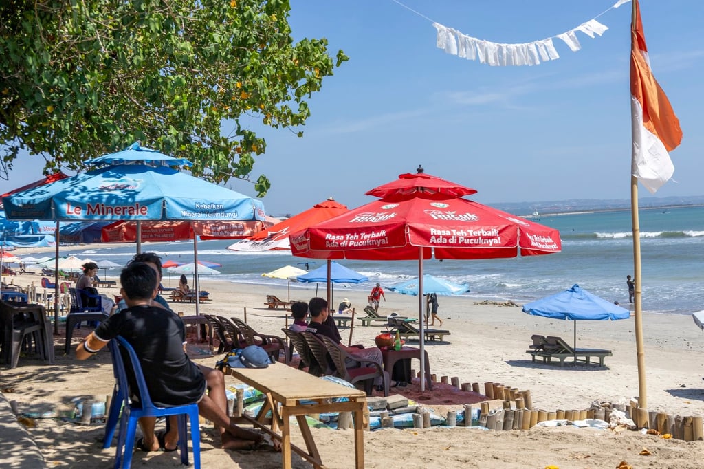 Tourists spend time at Kuta beach in Bali, Indonesia, on Tuesday. Photo: EPA