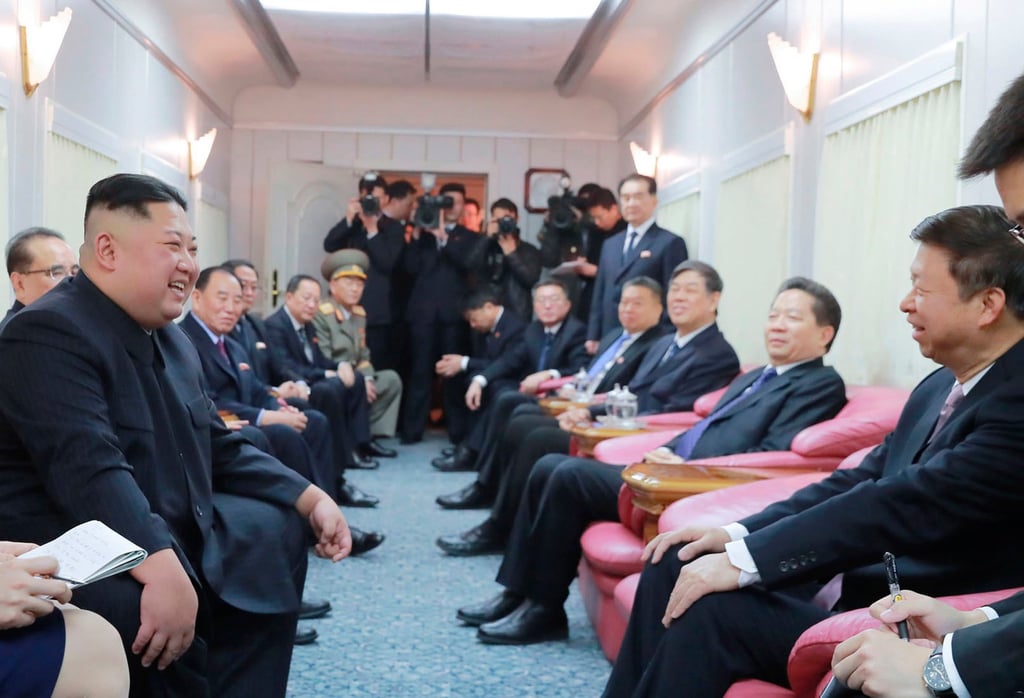 Kim Jong-un (left) talks to Chinese officials in a train on the way home from China on January 19, 2019. Photo: KCNA/AP