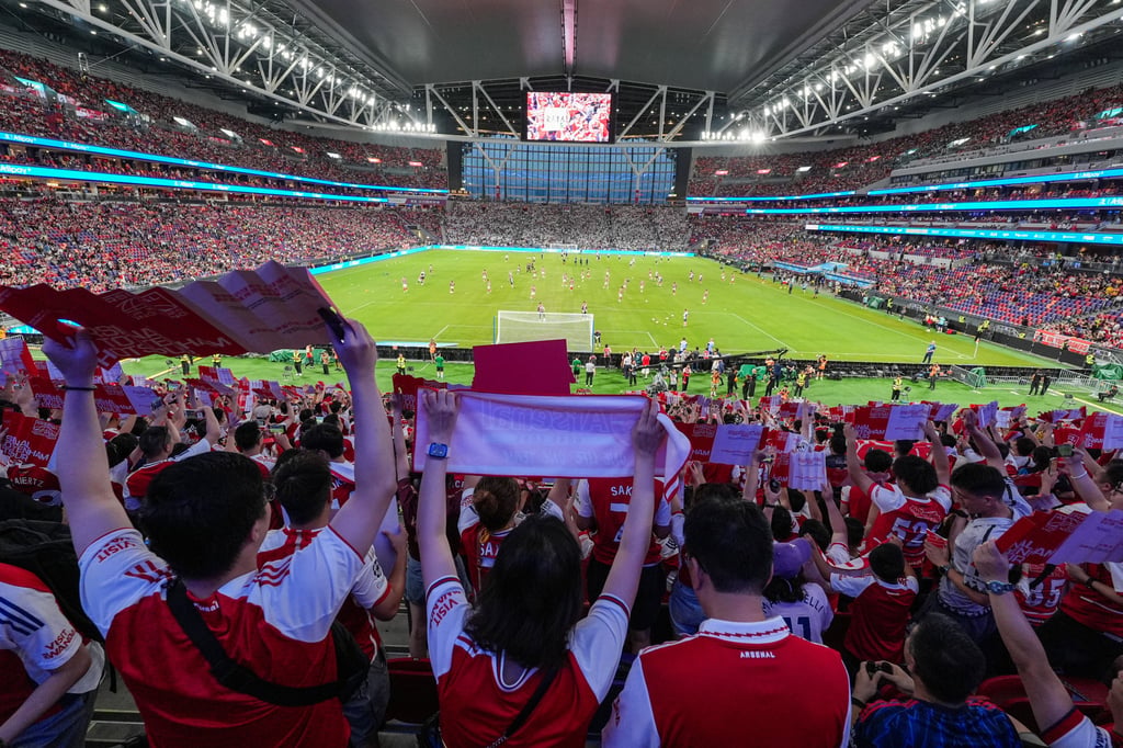 Fans watching a friendly between Arsenal and Tottenham Hotspur at Kai Tak Stadium. Photo: Elson Li