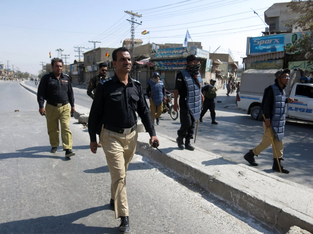 Police patrol after roads were blocked following opposition parties’ call for a strike to condemn the attack on a political rally of the Balochistan National Party in Quetta on Monday. Photo: EPA