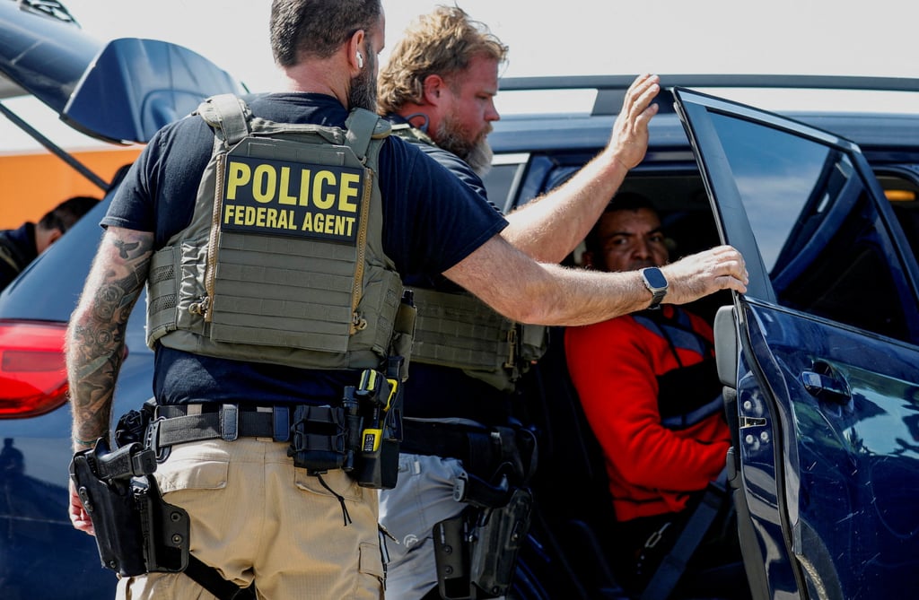 Federal agents detain a migrant near a Home Depot in Chicago. Photo: Reuters