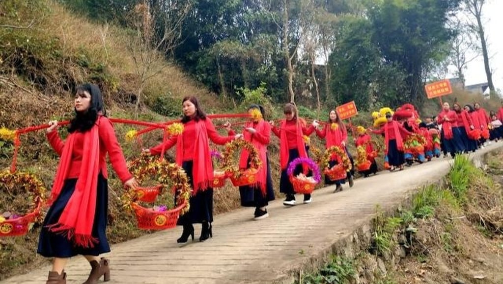 The Zhuang ethnic group tradition sees groups of married women travel home dressed in red and carrying offerings. Photo: Handout