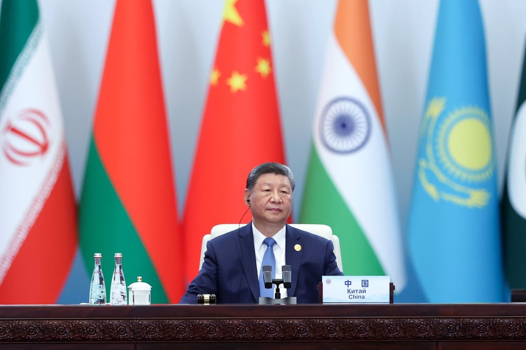 Chinese President Xi Jinping attends an SCO Plus format meeting in Tianjin on September 1 with the flags of member states seen in the background. Photo: Iranian Presidency/EPA