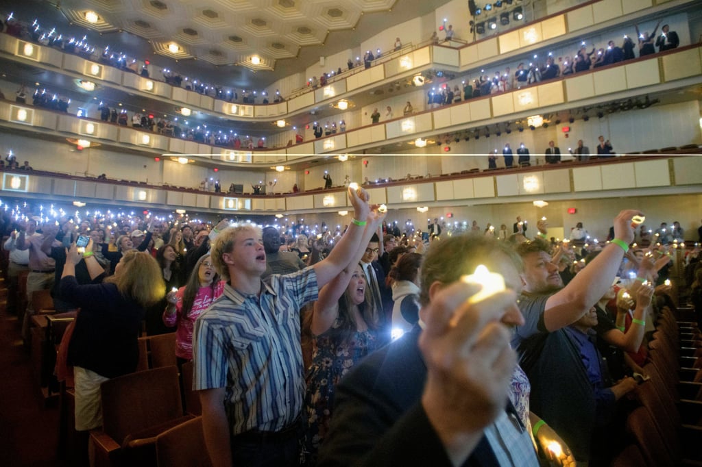 People hold candles and sing during a memorial and prayer vigil for Charlie Kirk at the Kennedy Centre on Sunday. Photo: AP