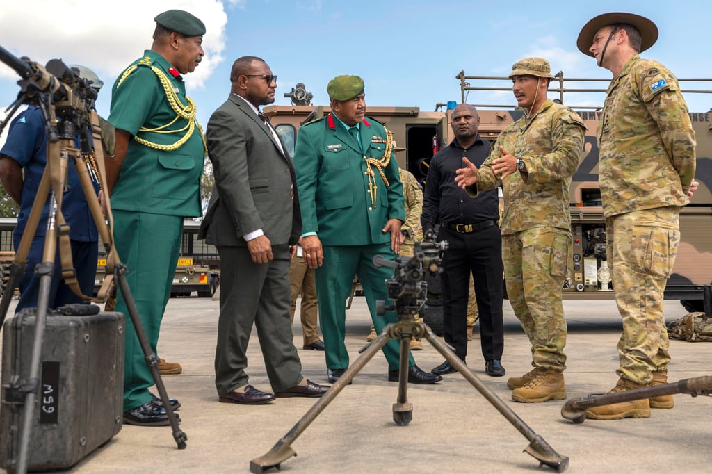 Australian soldiers talk to Papua New Guinea’s defence minister and other officials during a visit to Brisbane earlier this year. Photo: Australian Defence Force/AFP