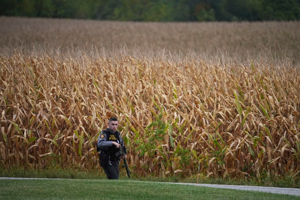 A state police trooper patrols a road after multiple police officers were shot and killed on Wednesday in North Codorus, Pennsylvania. Photo: AP