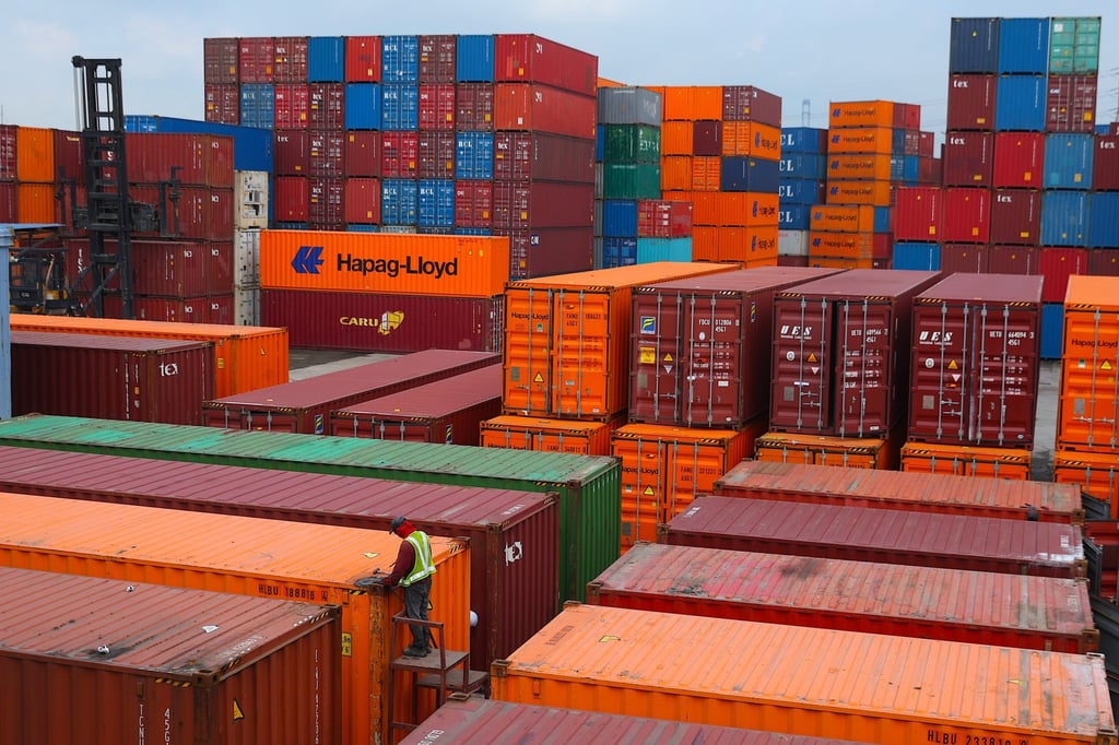 A man welds a cargo container at Port Klang, outside Kuala Lumpur, Malaysia, on September 10. Bank Negara Malaysia in July revised its growth forecast downwards to between 4 and 4.8 per cent this year. Photo: EPA