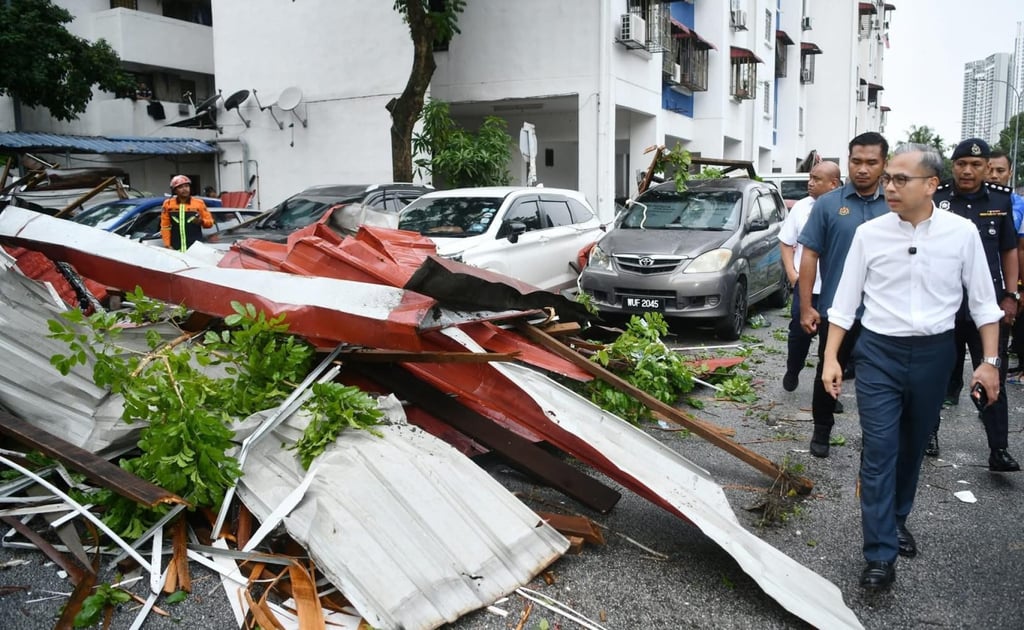 Lawmaker Fahmi Fadzil (right) visits a public-housing project in his constituency after its roofs were blown off by Monday’s storm. Photo: Facebook/Kuala Lumpur City Hall