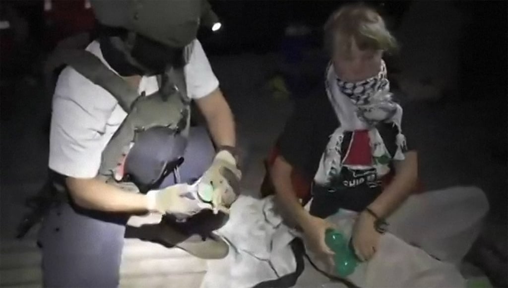This screenshot shows an Israeli soldier with Swedish climate activist Greta Thunberg (right) after several vessels of the Global Sumud Flotilla were stopped on Wednesday. Photo: Israeli Foreign Ministry/AFP