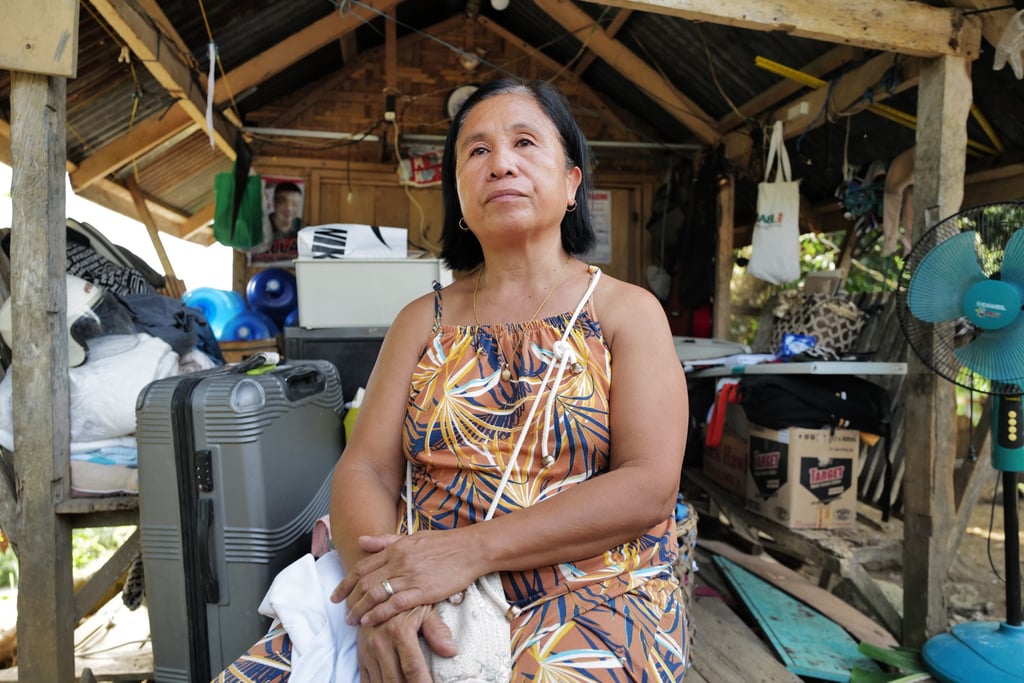 Vilma Lagnayo sits beside her destroyed house in Manay, Davao Oriental, after a magnitude 7.4 earthquake hit the southern Philippines on Friday. Photo: Jeoffrey Maitem