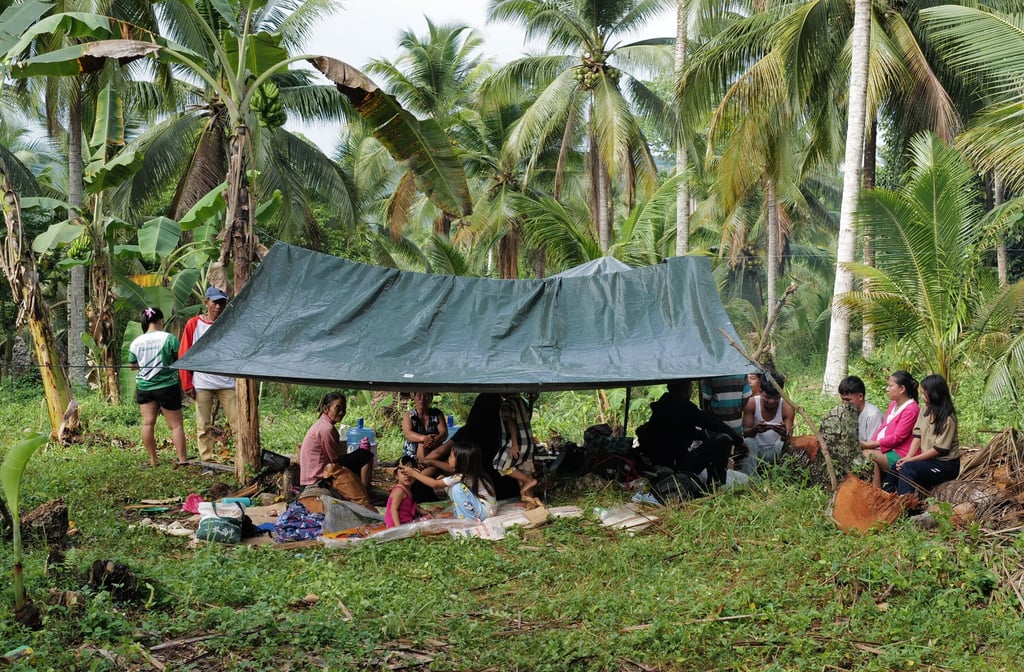 Residents stay under a tent at the earthquake-hit Manay on Saturday. Photo: AP