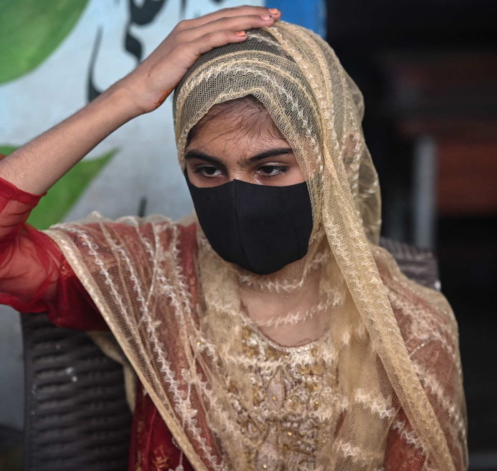 Sania, 13, helps her mother maintain a sprawling luxury home in Karachi. Photo: AFP
