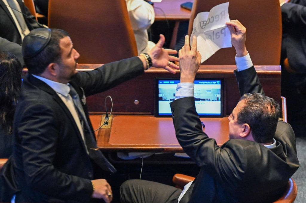 Israeli Knesset member Ayman Odeh holds a sign reading “Recognise Palestine” during President Donald Trump’s speech at the Israeli parliament on Monday. Photo: AFP