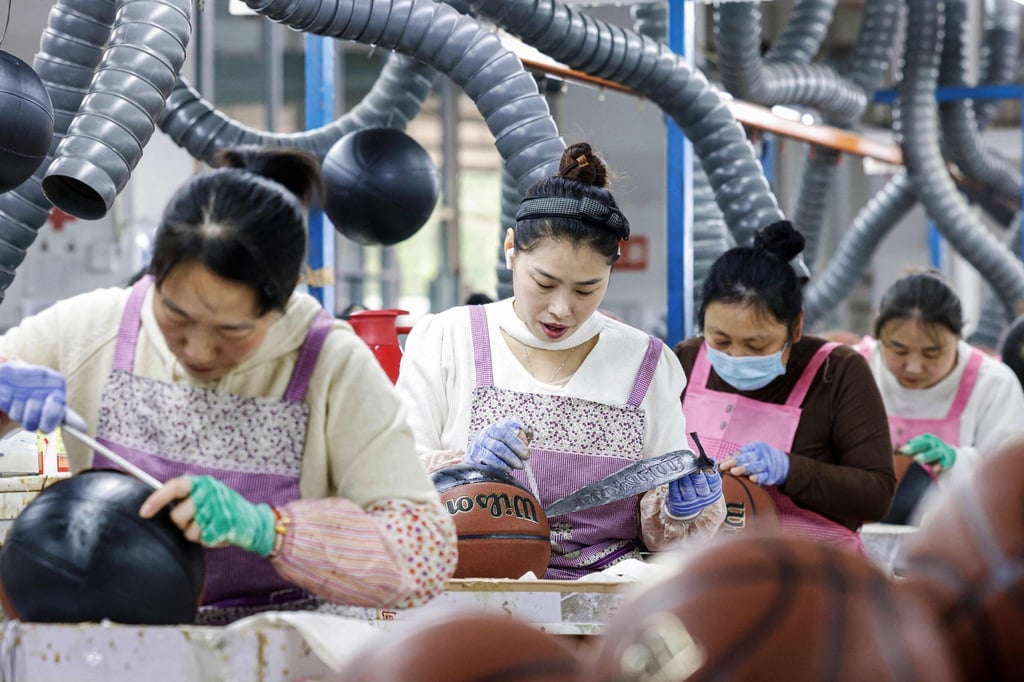 Employees produce basketballs that will be exported to Europe at a factory in Sihong, in eastern China’s Jiangsu province, on March 25. Photo: AFP