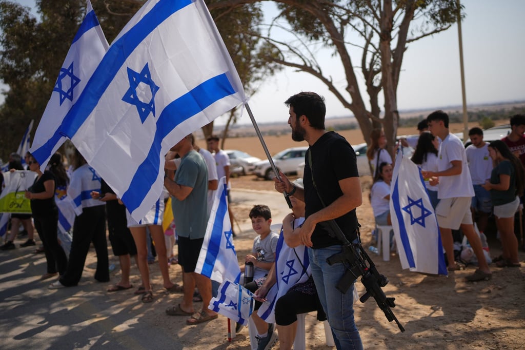 Friends and relatives celebrate before the arrival of the freed Israeli hostage Omri Miran in his home in the Kibbutz Kramim, Israel on Friday. Photo: AP