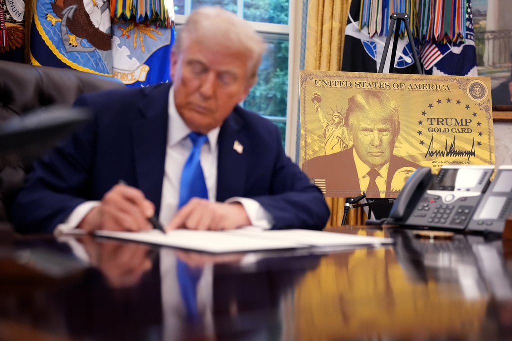 US President Donald Trump signs a series of executive orders establishing the “Trump Gold Card” and introducing a US$100,000 fee for H-1B visas at the White House in September. Photo: TNS