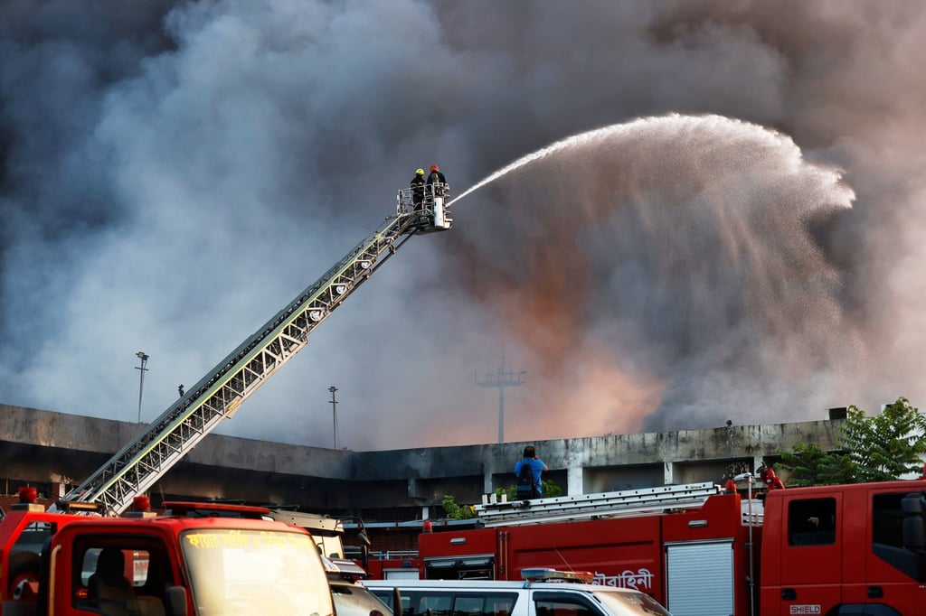 Firefighters try to contain a fire in the cargo area of Hazrat Shahjalal International Airport in Dhaka, Bangladesh, on Saturday. Photo: AP