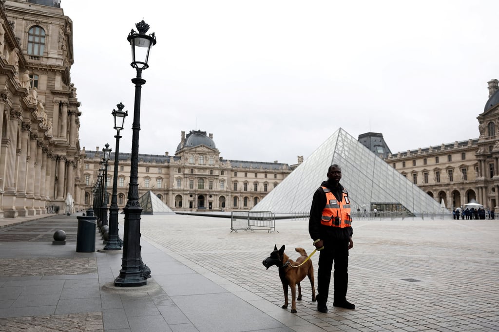 A security employee near the glass Pyramid of the Louvre Museum, which was closed on Monday. Photo: Reuters