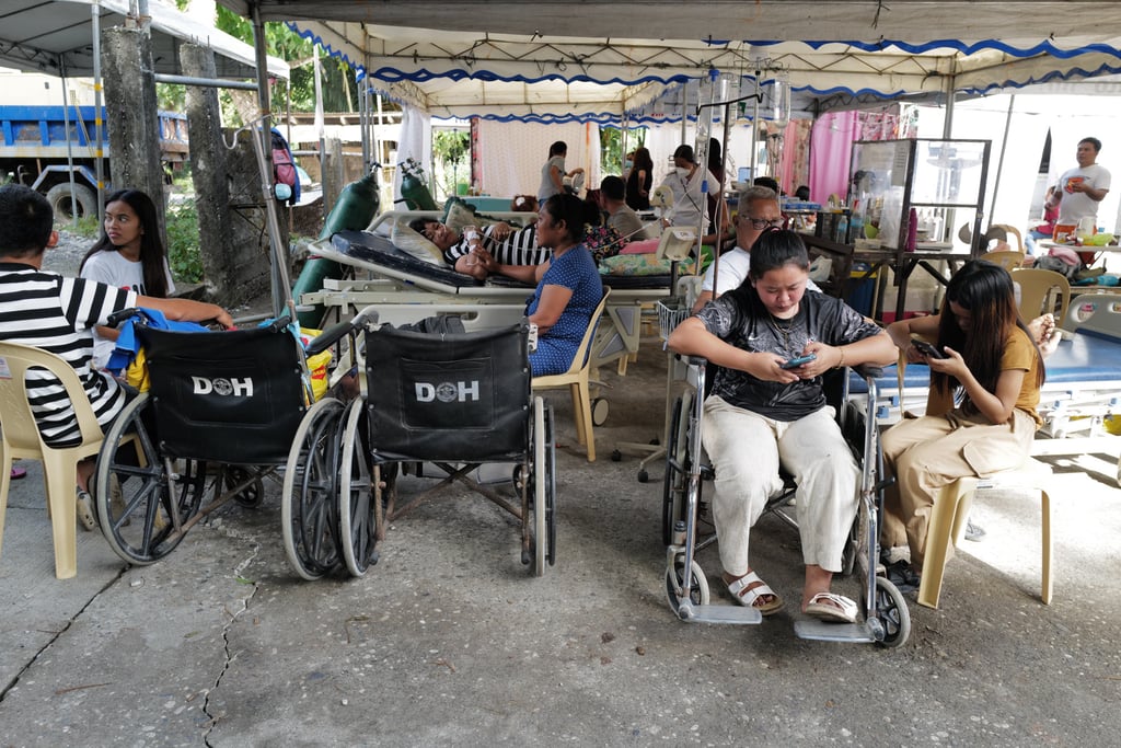Patients and their family members stay outside a hospital at the earthquake-hit Manay town, Davao Oriental province, southern Philippines, on October 11. Photo: AP