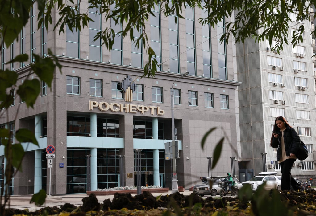 A pedestrian walks near an office building of Rosneft, one of Russia’s major oil companies, in Moscow, Russia, on Thursday. Photo: Reuters