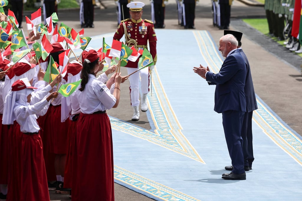 Brazil’s President Luiz Inacio Lula da Silva claps as he is greeted by students during a welcoming ceremony with Indonesia’s President Prabowo Subianto at Merdeka Palace in Jakarta, Indonesia, on Thursday. Photo: Reuters