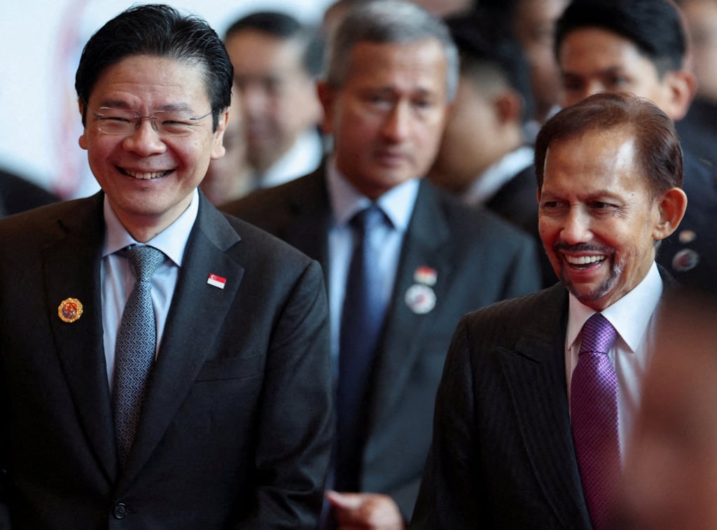 Singapore’s Prime Minister Lawrence Wong (left) walks with Brunei’s Sultan Hassanal Bolkiah at the 47th Asean Summit on Sunday. Photo: Reuters