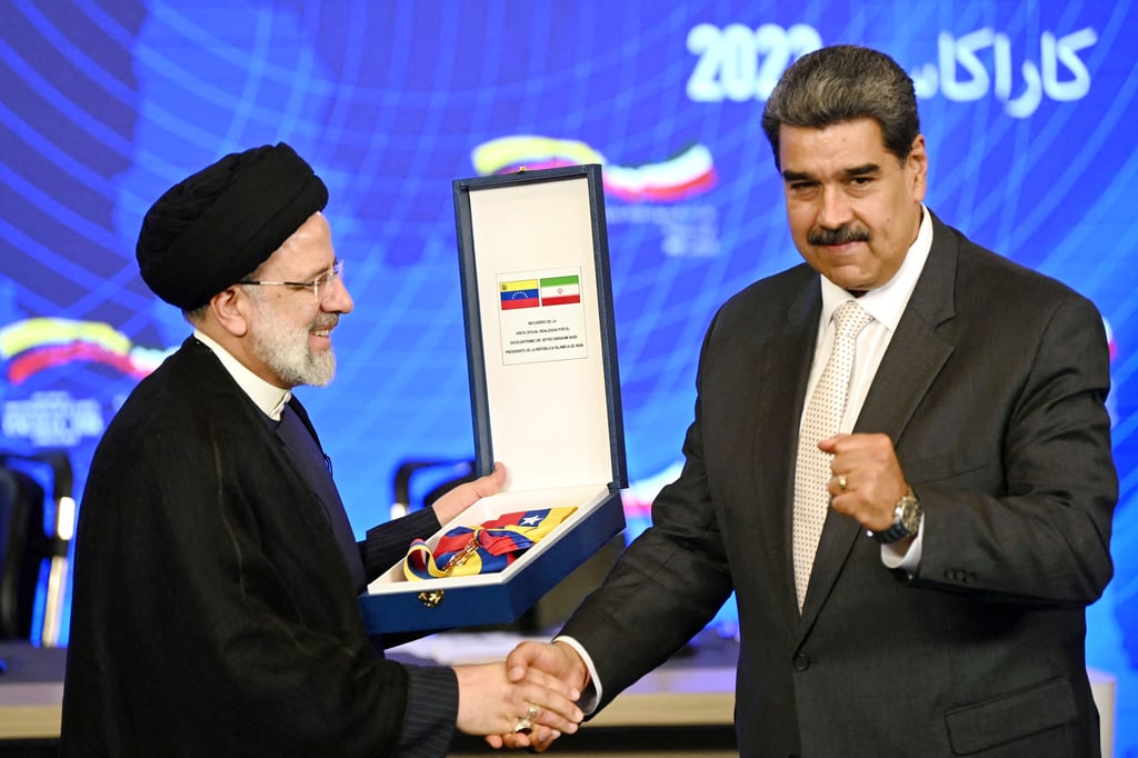 Iranian President Ebrahim Raisi (left) receives a commemorative decoration from Venezuelan President Nicolas Maduro in Caracas in June 2023. Photo: AFP