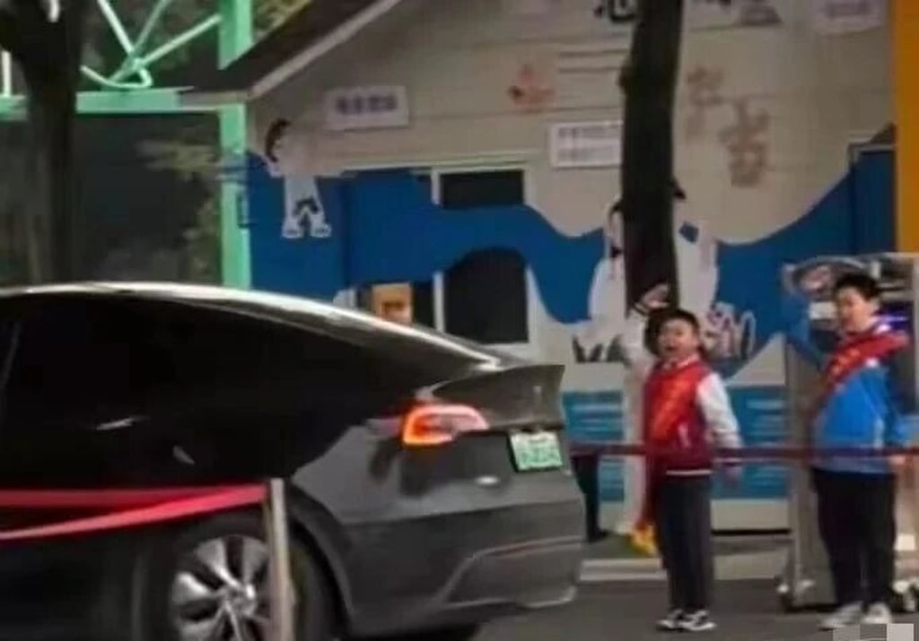 Two young pupils salute a teacher’s car as it pulls into the school one morning. Photo: Douyin
