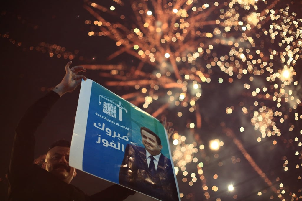 A supporter of Iraqi Prime Minister Mohammed Shia al-Sudani celebrates as fireworks go off in Tahrir Square on Wednesday. Photo: dpa