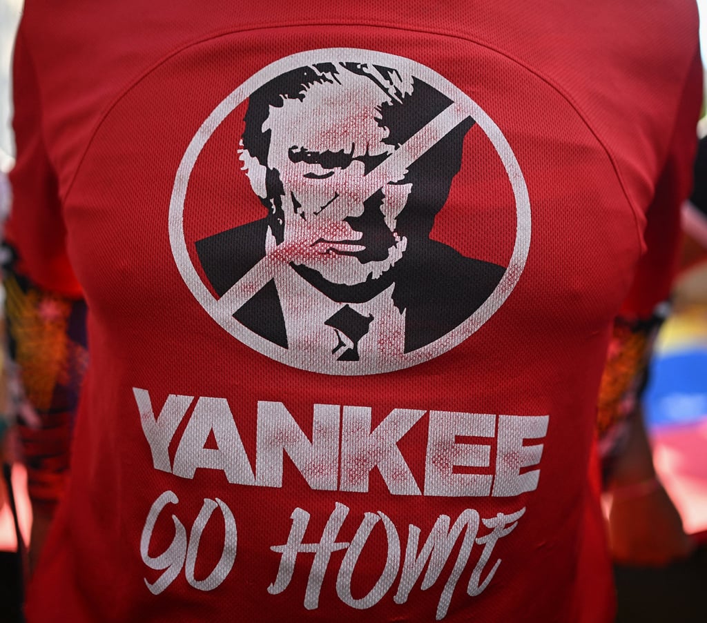 A supporter of Venezuelan President Nicolas Maduro wears a T-shirt depicting US President Donald Trump during a rally against US military activity in the Caribbean on October 30. Photo: AFP/ Getty Images