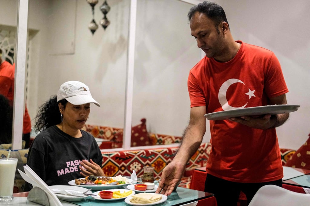 A waiter serves food to a customer at a Turkish restaurant in Dhaka on October 31. More Turkish restaurants are opening in Bangladesh and there is a general interest in learning the language. Photo: AFP
