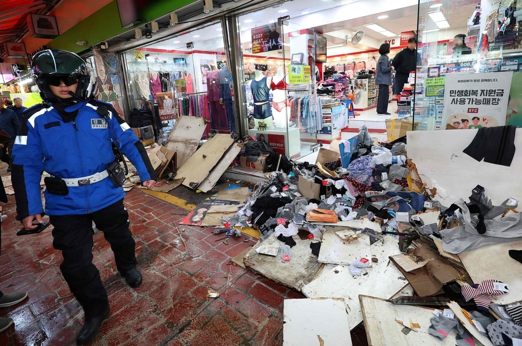 Police inspect the scene of the accident after a truck crashed into a local market in Bucheon on Thursday. Photo: Yonhap/AFP