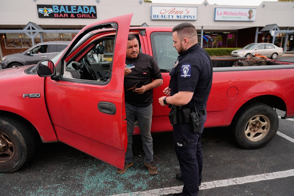 Willy Aceituno makes a police report after US Customs and Border Protection officers broke his truck’s window in Charlotte on Saturday. Photo: AP