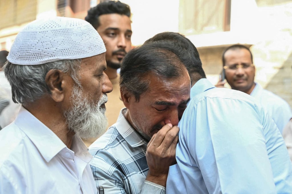 Family members and relatives of victims, who were killed in a bus accident near the holy city of Medina, mourn in Hyderabad on Monday. Photo: AFP