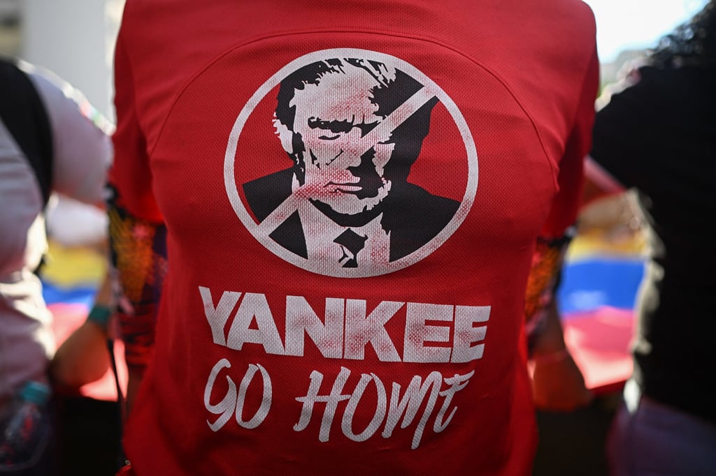 A T-shirt depicting US President Donald Trump with the slogan “Yankee go home” is worn by a Maduro supporter of during a rally against US military activity in the Caribbean, in Caracas last month. Photo: TNS