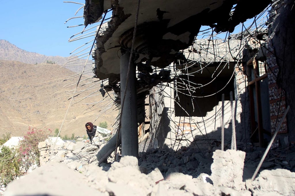 An Afghan man walks near a damaged house after an alleged Pakistani air strike in Kunar province on Tuesday. Islamabad has denied carrying out any attacks. Photo: AFP