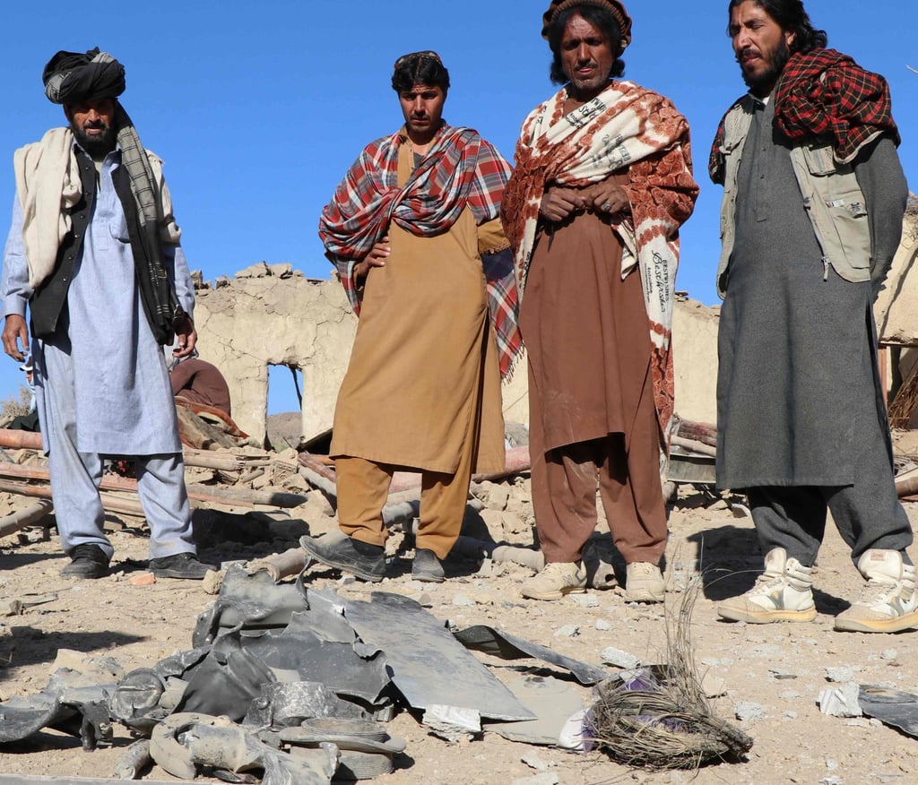 Afghan residents stand near remnants of a mortar shell at a house damaged by an air strike in Jige Mughalgai, Khost province, on Tuesday. Photo: AFP