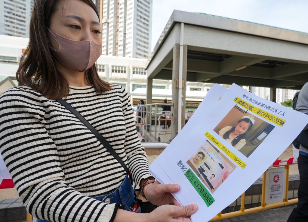 A woman distributes leaflets looking for a missing girl, Hannah, and her helper. Photo: Sam Tsang