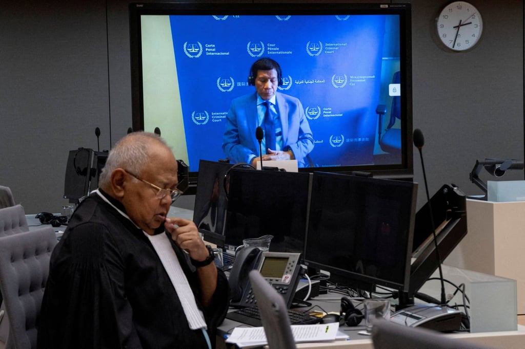 Rodrigo Duterte is seen on a screen in the courtroom of the International Criminal Court (ICC) with his lawyer Salvador Medialdea seated left, in The Hague, Netherlands, in March. Photo: Reuters