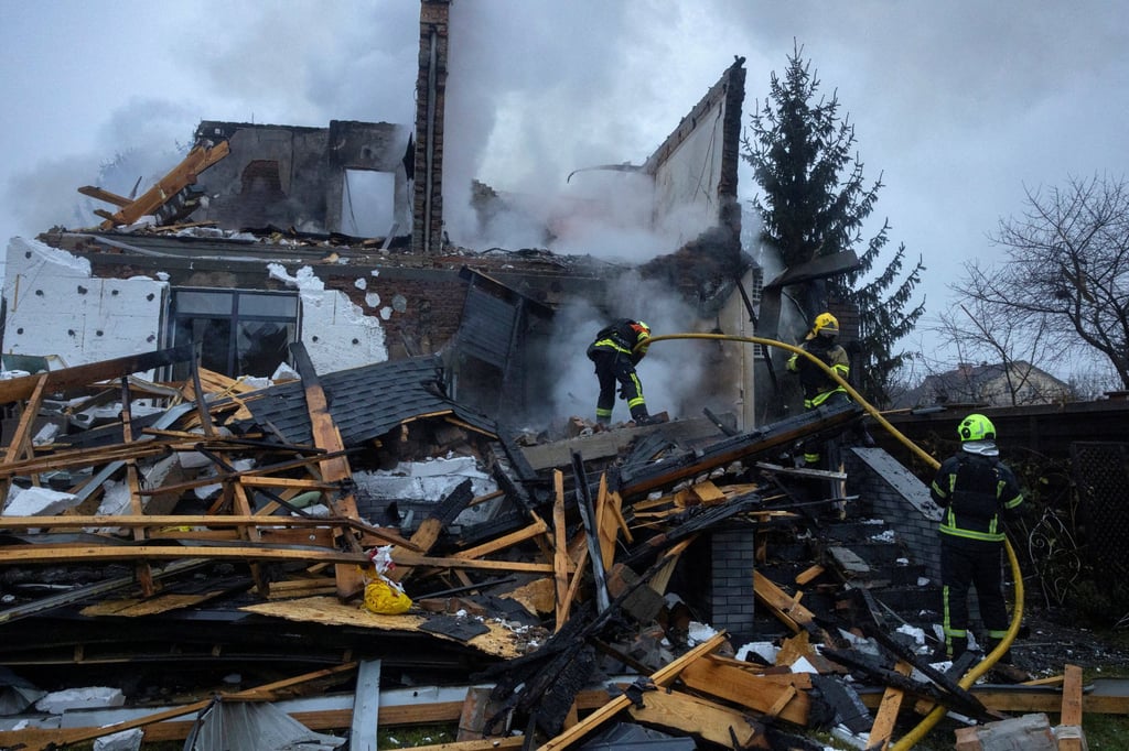 Firefighters work at the site of a home that went up in flames after it was hit by a Russian drone during a night of attacks on Kyiv. Photo: Reuters