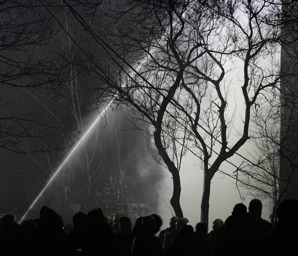Firefighters put out a blaze after a Russian attack in Vyshgorod early on Sunday. Photo: AP