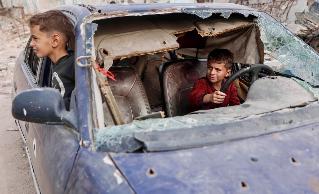 Displaced Palestinian children play in the wreckage of a car in the Tel al-Hawa neighbourhood of Gaza City on Saturday. Photo: AFP