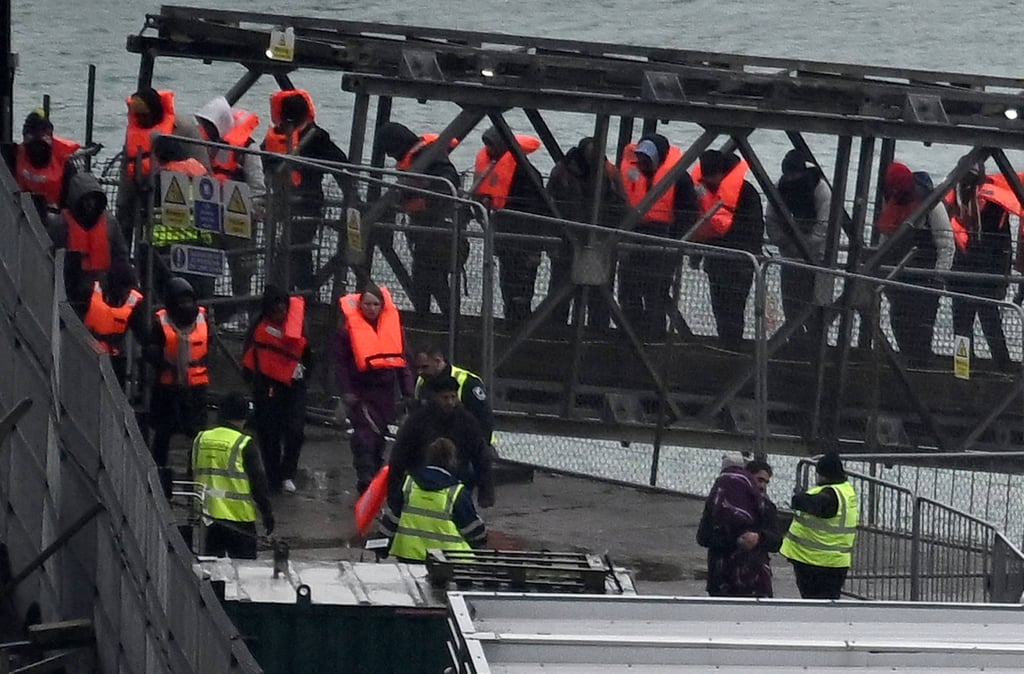 Migrants picked up at sea disembark in Dover, southeast England. Photo: AFP