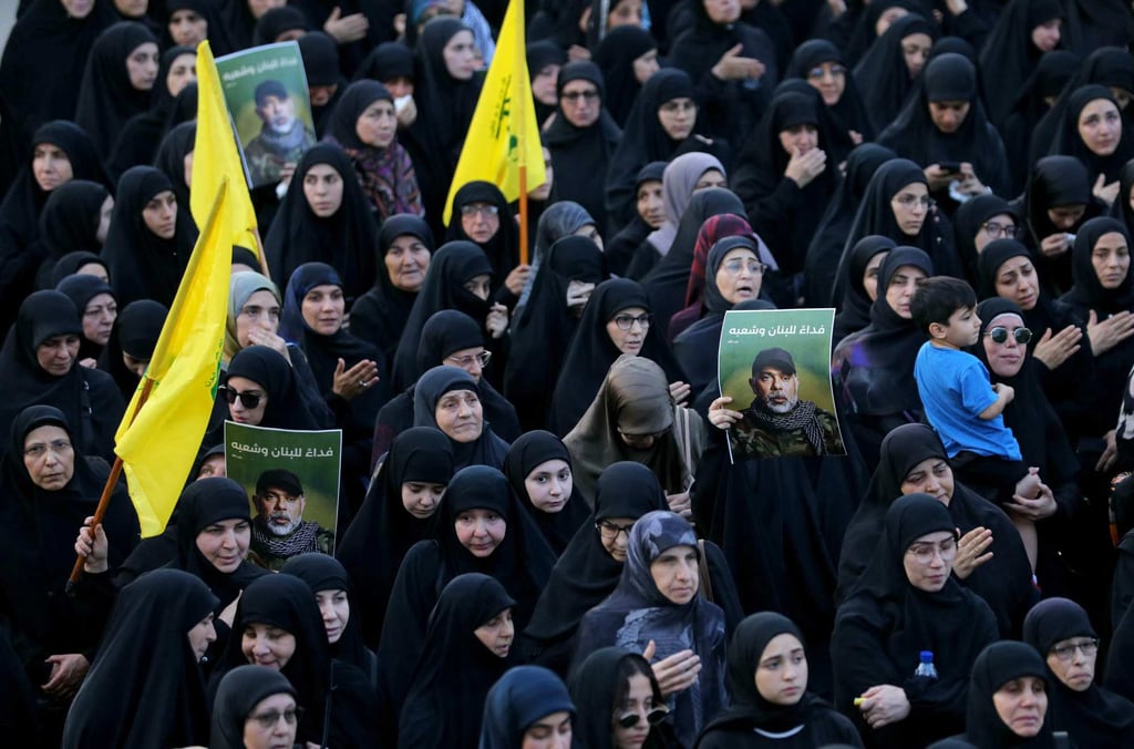 Mourners carry pictures of Hezbollah military chief Haytham Ali al-Tabatabai, who was killed in an Israeli strike a day earlier, during his funeral on November 24. Photo: AFP
