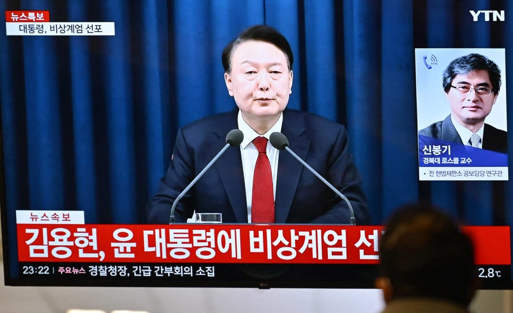 A man watches a broadcast of then South Korean president Yoon Suk-yeol declaring emergency martial law on December 3, 2024. Photo: AFP