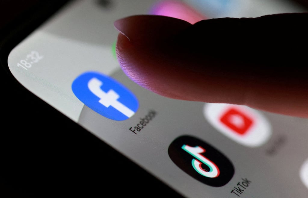 Facebook, TikTok and YouTube app icons are seen on a smartphone. Australia has passed a law prohibiting platforms from allowing under-16s to hold accounts. Photo: Reuters